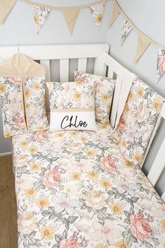 a baby crib bed with flowers and bunting