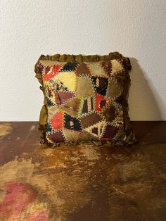 a decorative pillow sitting on top of a wooden table