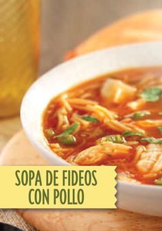 a white bowl filled with soup on top of a wooden table