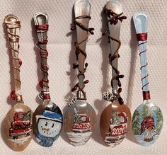 six christmas ornament spoons are lined up in a row