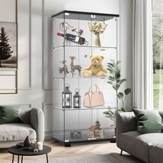 a living room filled with furniture and a teddy bear on top of a glass shelf