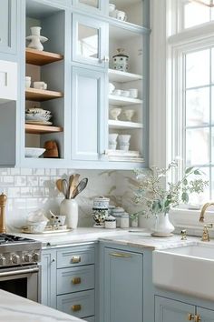 a kitchen with blue cabinets and white counter tops