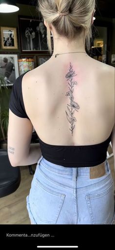 a woman with a flower tattoo on her back