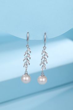 Long Leaf Freshwater Pearl Earrings Immerse yourself in the elegance of our Long Leaf Freshwater Pearl Earrings. These stunning pieces blend the serenity of nature with the sophistication of jewelry, featuring 8-9mm freshwater pearls set on long, leaf-shaped silver structures. Available in both gold and silver finishes, their 25mm length offers a stylish and refined addition to any ensemble. Product Details: Material: Silver Pearl: Freshwater Pearl, Size 8-9mm Design: Long Leaf Shape Earring Len Formal Silver Pear-shaped Pearl Earrings, Elegant Pear-shaped Sterling Silver Pearl Earrings, Elegant Pear-shaped Pearl Earrings In Sterling Silver, Silver Pearl Drop Flower-shaped Earrings, White Shell-shaped Pearl Drop Earrings, Leaf Earrings Silver, Gold Leaf Earrings, Freshwater Pearls Earrings, Zirconia Earrings