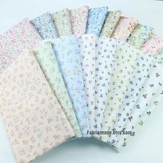 six different colors of fabric with small flowers on the front and back, all in various sizes