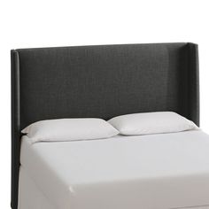 a bed with white sheets and pillows on top of it, against a white background