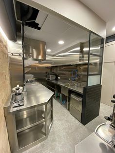 an industrial style kitchen with stainless steel appliances