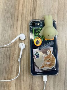 an iphone case with a cat and ear buds attached to it