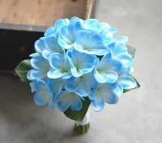 a bouquet of blue flowers sitting on top of a table