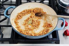 a frying pan filled with food sitting on top of a stove