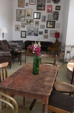 a living room filled with furniture and pictures on the wall