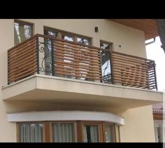 a balcony with wooden balconies and sliding glass doors on the side of a building