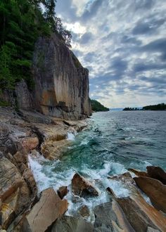 the rocky shore is lined with large rocks