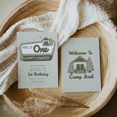 two cards are sitting on top of a wooden bowl