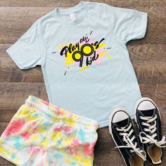 Play like a 90's kid - you know, more outside time and less screen time!  This shirt has a nostalgic 90's vibe.  Made from 100% ring-spun combed cotton, this classic youth jersey t-shirt is soft and comfy--great for an everyday outfit. If you want the family to match, you can find other sizes here! Toddler: https://www.etsy.com/QuietBookQueen/listing/1325308655/play-like-a-90s-kid-toddler-t-shirt Adult: https://www.etsy.com/QuietBookQUeen/listing/1325308987/play-like-a-90s-kid-adult-unisex-t-shirt * 100% ring-spun combed cotton * Soft jersey fabric * Fabric weight: 4.5 4.5 oz./sq. yd. (153 g/m²) * Crew neck and ribbed collar * Shoulder-to-shoulder taping * Double-needle stitched sleeves and bottom hem * Set-in sleeves * Blank product sourced from India, Mexico, Haiti, or Guatemala This pro 90s Inspired Blue T-shirt With Letter Print, 90s Inspired Multicolor Cotton T-shirt, 90s Style Pre-shrunk T-shirt For Summer, 90s Inspired Blue Cotton T-shirt, Unisex 90s Style T-shirt For Summer, 90s Inspired Pre-shrunk Summer T-shirt, 90s Inspired Summer T-shirt With Funny Print, 90s Inspired Funny Print T-shirt For Spring, 90s Inspired T-shirt For Summer Fan Merchandise