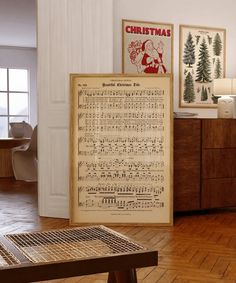 an old sheet music is on display in a room with wood floors and white walls