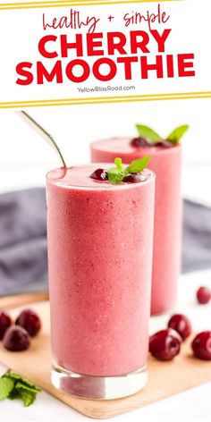 two glasses filled with berry smoothie and garnished with mint leaves on a cutting board