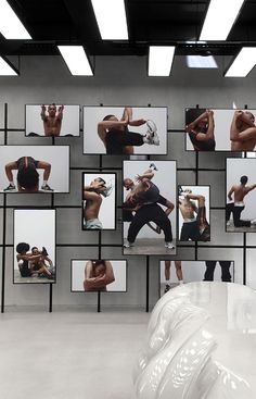 an art installation with multiple images of people doing different things on the wall and in front of them