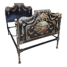 an ornate iron bed frame with painted scenes on the headboard and foot board,