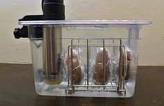 two breads in a basket on a table next to a water dispenser