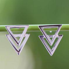 Super-imposed triangles set a geometrical spell of elegance in earrings by Lalana. The Thai artisan works in sterling silver giving the earrings a limpid high polished finish. Pyramid-shaped Sterling Silver Jewelry Gifts, Sterling Silver Pyramid Jewelry As Gift, Sterling Silver Pyramid Jewelry For Gifts, Geometric Sterling Silver Jewelry In Silver, Minimalist Silver Pyramid Jewelry, Sterling Silver Triangle Earrings For Pierced Ears, Modern Nickel-free Triangle Earrings, Elegant Triangle-shaped Jewelry, Silver Triangle Minimalist Earrings