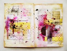 an open book with lots of different colored papers and ink splatters on it