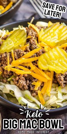 a bowl filled with lettuce, cheese and ground beef on top of a wooden table