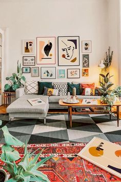 a living room filled with lots of furniture and pictures on the wall above it's coffee table