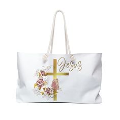 a large white bag with flowers and a cross on the front that says, jesus