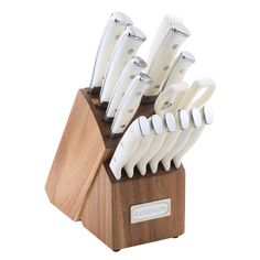 a wooden block holding many white knives on it's side, with the blades still attached