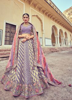 Woven zari Banarasi silk lehenga choli in Lavender 6010 Desc:  Style : A-Line Lehenga Choli Color : Lavender Fabric : Silk   Work : Heavy Jacquard Woven With Embroidery & Stone Work Wash Care : Dry clean Sleeve Style : Half Sleeve Long Sleeves : Done only in Custom Stitch Sleeves Lining : Done only in Custom Stitch Bust Size : 32 to 42 Inches Occasion : Wedding   Mehendi   Sangeet   Engagement   Reception   Ceremonial   Baby ShowerShop Banarasi lehenga,silk lehengas,heavy bridal le Luxury Cotton Silk Lehenga With Zari Weaving, Luxury Zari Weaving Lehenga For Traditional Ceremonies, Luxury Zari Weaving Choli For Eid, Luxury Handloom Jamawar Lehenga, Luxury Handloom Lehenga For Eid, Luxury Lehenga With Zari Weaving For Traditional Ceremonies, Luxury Banarasi Silk Lehenga For Eid, Luxury Chanderi Lehenga For Puja, Luxury Dola Silk Lehenga With Zari Work