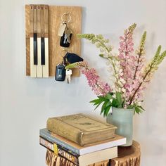 a vase filled with flowers sitting on top of a wooden table next to a book