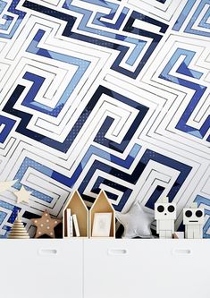 a room with blue and white geometric wallpaper