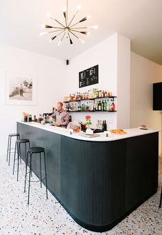 a man is behind the bar at a restaurant