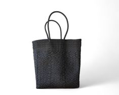 This Black Mexican artisan tote is a one-of-a-kind, handmade shoulder bag that combines elegance and traditional craftsmanship. Exclusive Artisan Craftsmanship: Handwoven by skilled artisans—only one piece available. Elegant Black Design: A classic black tote that pairs effortlessly with any outfit. Open-Top for Easy Access: Reach essentials quickly without closures or zippers. Comfortable Long Handles: Designed for convenient over-the-shoulder wear. Multi-Purpose Use: Perfect for shopping, office, beach outings, or daily adventures. Durable & Easy to Clean: Maintains shape, lightweight, and easy to keep looking fresh. Dimensions: 14 x 7 x 15 inchesColor: Black Traditional Black Travel Bag, Traditional Black Rectangular Bag, Traditional Black Rectangular Shoulder Bag, Traditional Black Tote Bag, Traditional Black Tote Shoulder Bag, Traditional Black Shoulder Bag As Gift, Traditional Black Shoulder Bag Gift, Traditional Black Shoulder Bag For Gift, Traditional Black Bag For Everyday Use