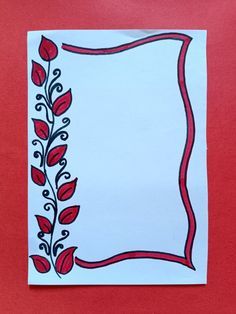 a piece of paper with a red and black flower design on the bottom, in front of a white background