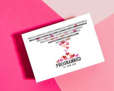 a business card with the word programmed printed on it and hearts coming out of it