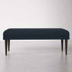 an upholstered bench with wooden legs and a dark blue fabric seat cover on it