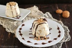 two desserts on plates with chocolate sauce drizzled over them and nuts