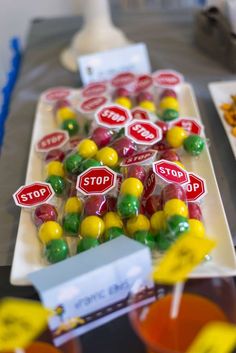 there are many candies on the table with stop signs in front of them,