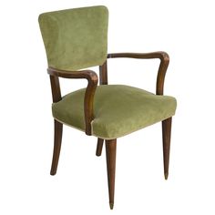 a green chair with wooden legs and arms