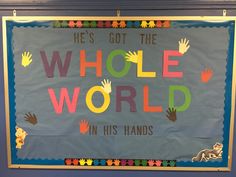 a bulletin board with handprints on it that says he's got the whole world in his hands