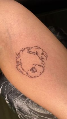 a woman's arm with a tattoo on it that has a circular design in the middle