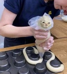 a woman holding an animal wrapped in plastic