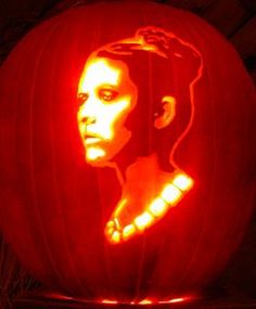 a pumpkin carved to look like elvis presley