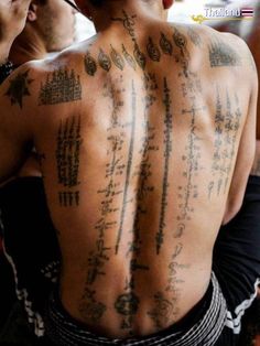 a man with many tattoos on his back