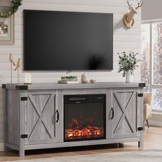 an entertainment center with a fireplace in the middle and a flat screen tv above it