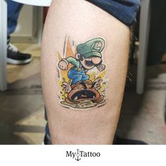 a cartoon tattoo on the leg of a man