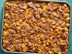 a baking pan filled with chocolate and tortilla shells on top of a blue surface