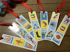 several children's playing cards are laid out on the floor with red ribbon around them